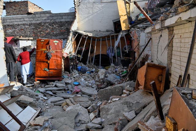 <p>Government officials survey the damage of a home caused by a gas cylinder explosion hours after a wedding reception, in Islamabad, Pakistan, on 11 January 2026. (AP Photo/Ehsan Shahzad)</p>