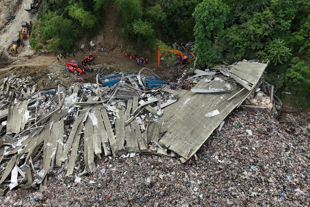 <p>Rescuers search for missing workers at a collapsed waste segregation facility in Cebu City</p>
