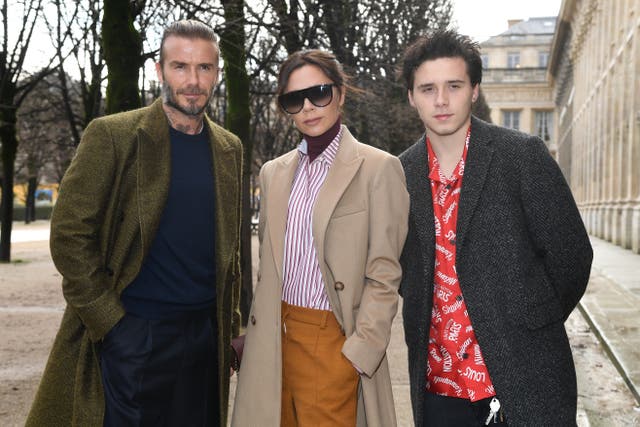 <p>Brooklyn Beckham pictured with his parents, David and Victoria</p>